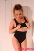 Busty babe in a ponytail and black lingerie exposing her tits
