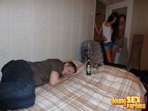 Bisexual girls and a guy enter the room of a sleeping man and engage in sex next to him while he sleeps. - Picture 1