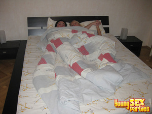 A couple sleeping naked in their bed wake to find a randy couple ready to tangle in the sheets. - Picture 1