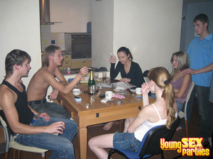 Large group of friends smoke cigs and cajole before piling onto sofa and adjacent twin bed for orgy. - Picture 1