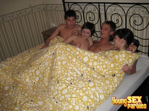 Four classy friends get cozy in a sizable bed before casual coitus commences. - XXXonXXX - Pic 1