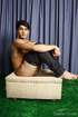Young man with dark features shows off his rock hard body when pulling