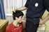 Male teen in a red tee obeys the law when officer commands him to deep-throat.