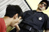 Male teen in a red tee obeys the law when officer commands him to deep-throat.