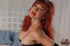 Smoking hot redhead displays her stunning curves and luscious boobs wearing
