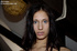 Whore with bright blue eyes has her hands tied behind her back from a