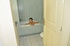 Alluring honey with a patch of thin pussy hair poses nude in a tub of