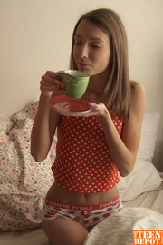 Teen brunette kneels down on a white bed and sucks her boyfriend's dick wearing her red and white polka dotted top and strawberry printed panty before she turns around and lets him drill his cock deep inside her ass crack.