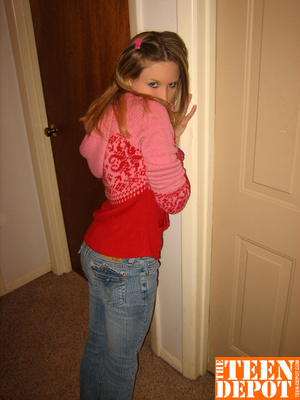 Cute teen hottie takes off her pink and red sweater and blue jeans then bares her skinny body and hot ass before she removes her pink and white thong and rubs her pussy in different positions by a door. - Picture 3