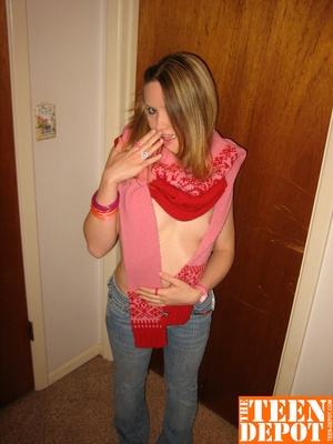Cute teen hottie takes off her pink and red sweater and blue jeans then bares her skinny body and hot ass before she removes her pink and white thong and rubs her pussy in different positions by a door. - Picture 6