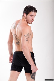 Two athletes down to their bare essentials with one in fitted briefs and the other in a fitted jock.