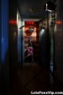 Curvy damsel in pink models and poses in hallway to show seductive assets