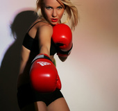 Hot blonde fighter posing her sexy curves in black gym outfit and red