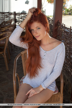 Ravishing redhead is sheltered from the  - Picture 2