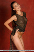 Svelte model gets naked before sitting atop a wooden stool to showcase