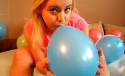 Blonde preggo inflating balloons and posing