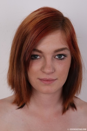Pretty redhead strips down her orange tu - Picture 1