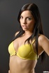 Enchanting slut in yellow undies takes her bra off in front of a grey
