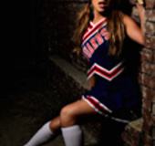 Pigtailed tranny posing in cheerleader's uniform