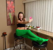 Skinny teen in green pantyhose feeding her cunt with a cucumber and banana