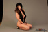 Adorable strumpet posing in red lingerie in front of a grey background