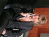 Old blonde wearing black jacket, blouse, slacks and high heels takes them