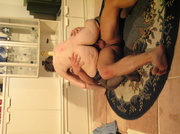 Old chick wearing black stockings sucks a younger guys dick then lets him bang her in different positions before she wanks his cock and make it spray jizz in her mouth in a living room.