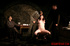 Guards in uniform feeding a dildo to a naked prisoner in the interrogation