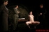 Bare gal tied to a chair gets slapped around by her interrogators.