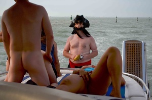 Chubby babes make out with hairy masked men on a boat in the middle of water - Picture 2