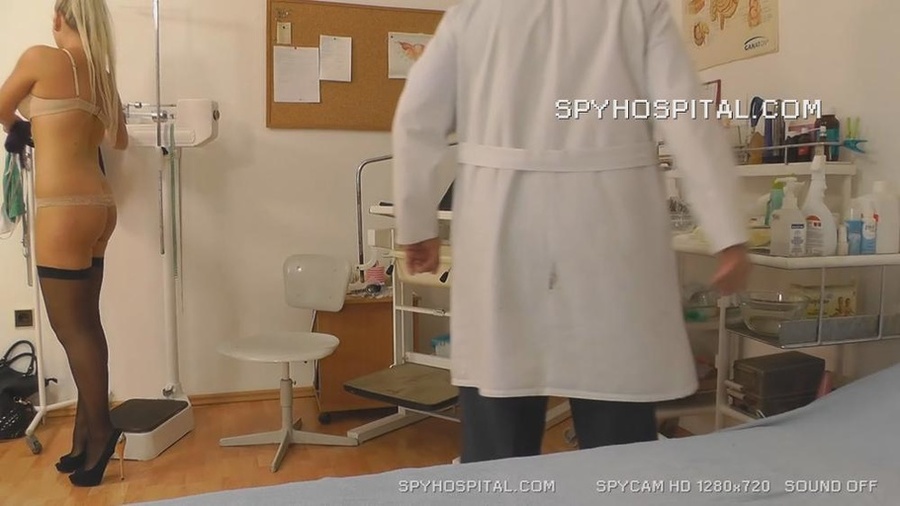 Blonde hottie wearing purple dress, black stockings and high heels gets naked then lets her doctor examine her pussy as she lets him drill different tools between her wide spread legs on a black seat. - XXXonXXX - Pic 10