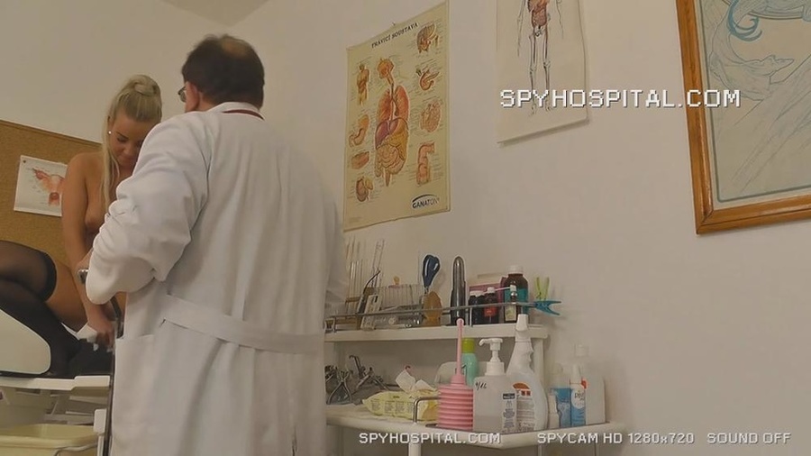 Blonde hottie wearing purple dress, black stockings and high heels gets naked then lets her doctor examine her pussy as she lets him drill different tools between her wide spread legs on a black seat. - XXXonXXX - Pic 12