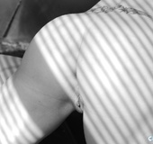 Enchanting naked tramp captured in black and white displaying her quim.