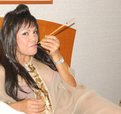 Queer smoking a pipe shows off her big cigar in bed.