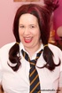 Mature chick in pigtails wearing school uniform strips off her white blouse