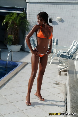 Outstanding black darling drops her orange bikini by the pool. - Picture 1