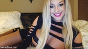 Amazing blonde hottie releases her big boobs out of her sexy black dress then displays her hot curved body on a white bed before she takes off her pink and black panty.
