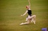 Lovely shiela in flowing clothing does some ballet on grass.