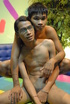 Ponytailed Asian twink in glasses and his friend posing in clothes and