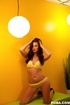 Gorgeous brunette posing her hot curves in yellow bikini before she strips