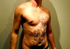 Hunk dude displays his muscular body with floral designed hena tattoos