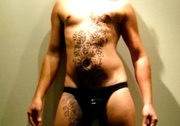 Hunk dude displays his muscular body with floral designed hena tattoos and his hot butt then takes off his black brief and expose his big dick.