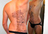 Hunk dude displays his muscular body with floral designed hena tattoos