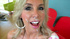 Charming shiela in a pink and white dress takes a facial in the gameroom.