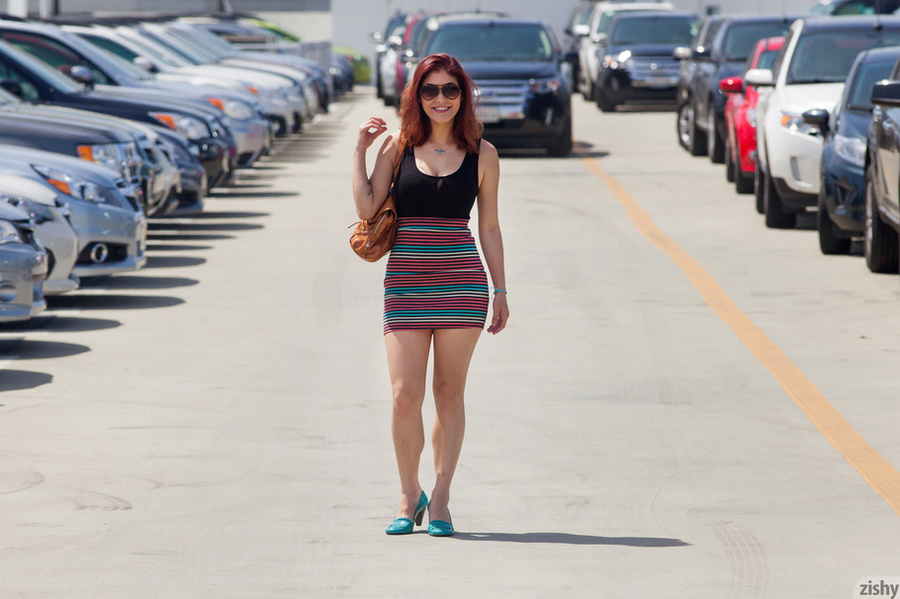 Mischievous brunette teen in a short skirt  - XXX Dessert - Picture 1
