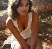 Hot brunette seductress looks very sexy in this long white dress outdoors