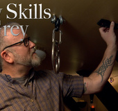 Two guys get the diabolic dungeon devices and stuff prepared for action.