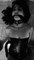Black and white pics of brunette slave in a corset and fishnet gagged