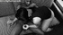 Curvy submissive girl in a black vest giving hand- and blowjob to black