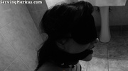 Brunette submissive girl in corset and fishnet gets blindfolded and gagged with hands in cuffs